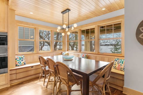 Gather around your cozy breakfast nook with built-in benches and colorful cushions, where warm wood tones and natural light create the perfect spot for morning coffee.