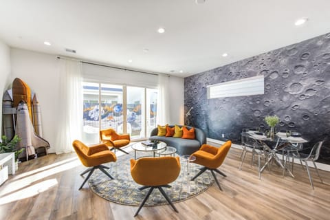 A cozy setup with a sofa, four Eames chairs, and a center table