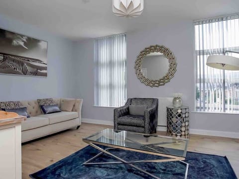 Spacious living area where all the guests can relax together. A relaxing space furnished with comfortable but stylish pieces accompanied by a smart tv,  perfect for some down time together. 