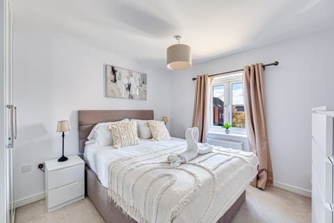 The master bedroom has a king-size bed with fresh linen and towels provided.