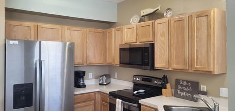 Modern, well-stocked kitchen with stainless appliances and generous cabinet space.