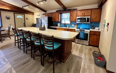 Kitchen with large eat in bar