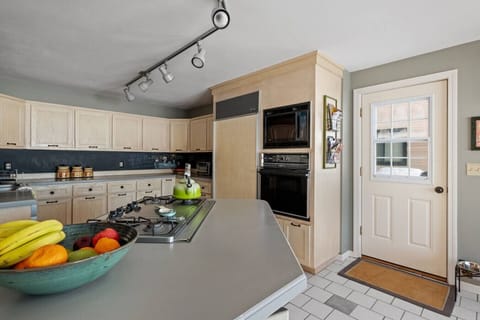 Functional and stylish kitchen with breakfast island and convenient layout for families or groups.