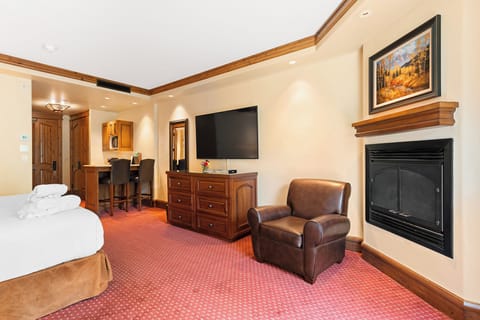 Stretch out in this spacious suite with fireplace and big TV.