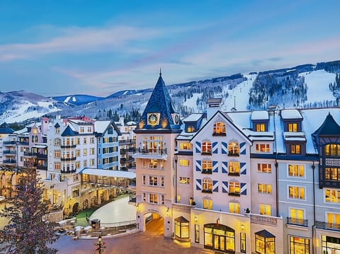 Arrive to a storybook alpine hotel glowing beside snowy slopes