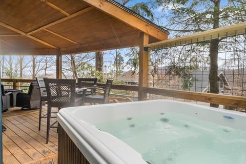 Cozy Deck with Hot Tub, Outdoor Seating, Gas Grill, and Fire Table