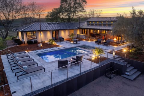 Take in the stunning elevated view of the pool area, complete with inviting loungers for the perfect day under the sun.