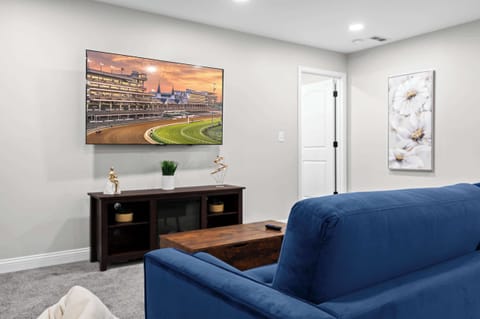 Living Room: Catch your favorite shows in this cozy living area featuring a sleek TV setup and modern decor.