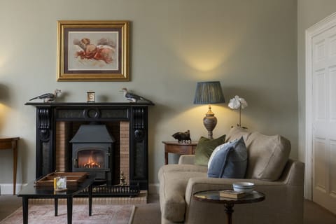New Ladykirk Farmhouse - the log burner and comfy seating in the drawing room