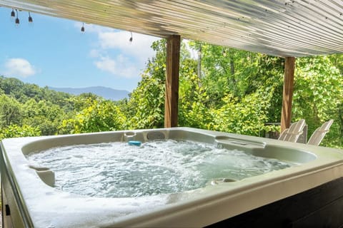 Soak away your cares in your private hot tub while mountain views and lush green forest surround you beneath a covered canopy. Pure bliss awaits.