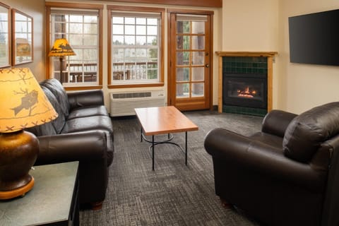 Gather by the glowing fireplace for relaxed evening lounging.