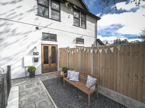 Wooden bench in the garden. Wooden fence around all the garden.