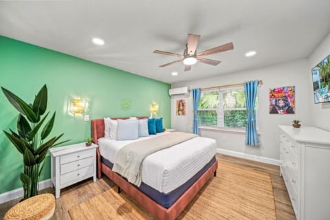 Bedroom Suite 1  with Queen Bed and Dresser Space: Vibrant green walls and plush bedding create a tranquil escape in paradise!
