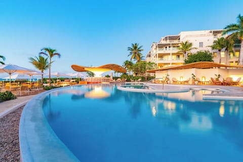 Dive into a palm-framed lagoon pool at golden hour.