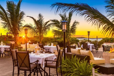 Toast sunsets over the water from an elevated dining terrace.