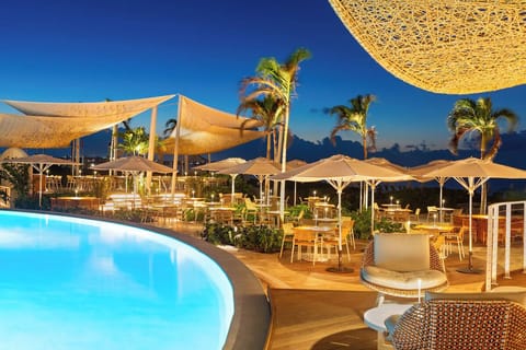 Gather poolside for relaxed conversation beneath breezy canopies.