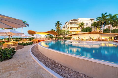 Unwind poolside at sunset with cocktails and ocean breezes.