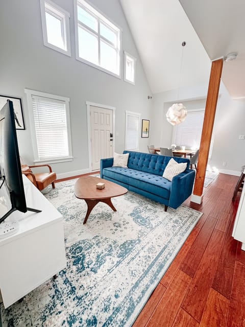 Bright living and dining area with vaulted ceilings and natural light