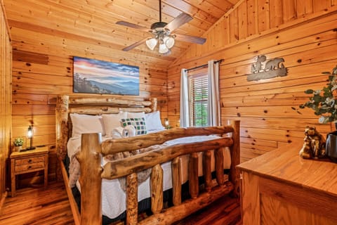 Main bedroom with king bed, Roku TV, and charging ports on bedside table lamps
