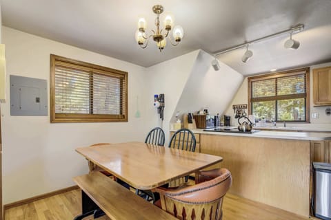 Gather around this charming dining nook for breakfast or board games, just steps from the fully equipped kitchen and bathed in soft natural light from the window.