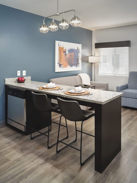 Gather for relaxed meals at the granite counter with seating.