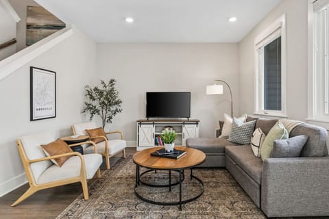 Bright and cozy living room with a Smart TV, Queen size sofa bed, and room-darkening shades.