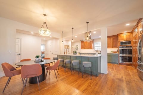 Gather in this stunning kitchen with a spacious island, modern lighting, and premium double ovens, where family moments and entertaining come together beautifully.