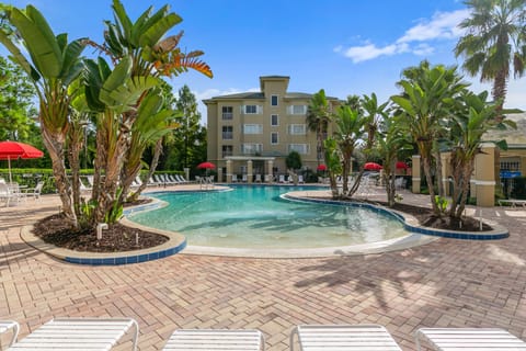 Dive into relaxation at this beautiful pool area surrounded by lush greenery and inviting lounge chairs, perfect for soaking up the sun and enjoying the tranquil atmosphere.