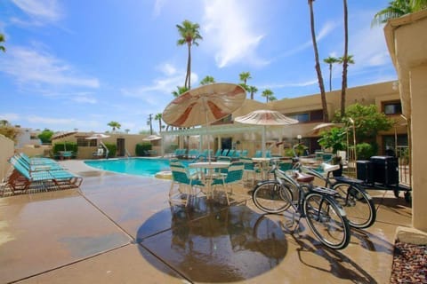 Soak up the sun by the pool, complete with lounge chairs and umbrellas in a peaceful desert setting perfect for relaxation.