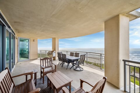 South Beach balcony with grill, dining, and lounge seating — soak in panoramic Gulf views in style!