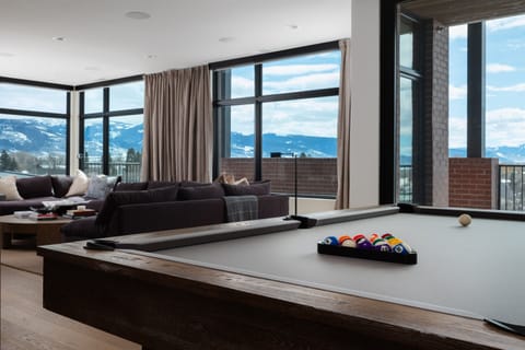 Welcome to The Grand—where elevated design meets mountain views, complete with a stylish pool table for casual fun.