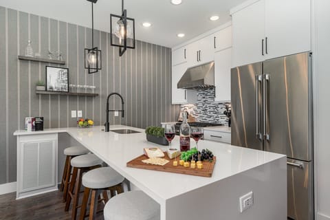 2nd Floor: Fully equipped kitchen with stainless steel appliances and a kitchen island with seating for 4 guests.