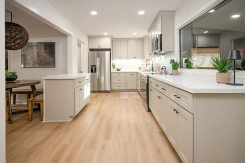 Large kithen with ample counter space, electric range, serving bar and everything you need to make a meal at home