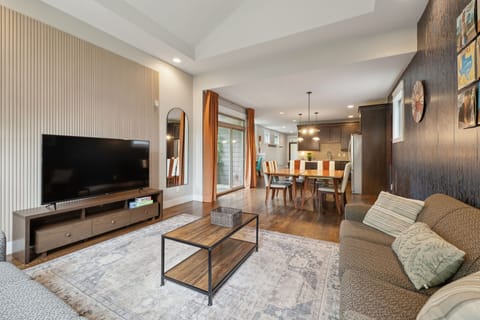 Living Room: Unwind on comfy couches, framed by striking Art Deco wallpaper and retro vinyl art. Style meets comfort in every corner.