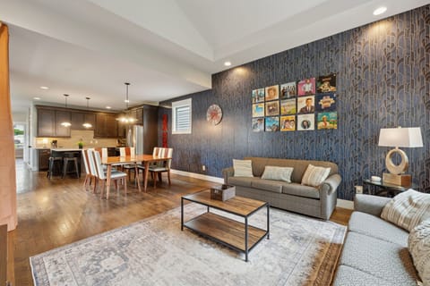 Living Room: Unwind on comfy couches, framed by striking Art Deco wallpaper and retro vinyl art. Style meets comfort in every corner.