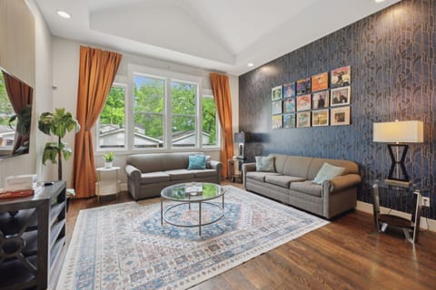 Living Room: Golden drapes, plush seating, and a sleek TV console create a warm, modern vibe. A perfect place to relax or entertain.