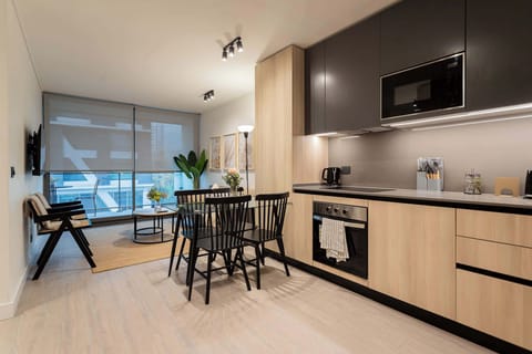 Experience modern elegance in this stylish kitchen and dining area, perfect for cozy meals and gatherings.