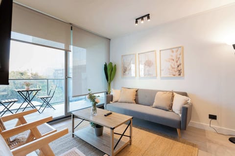 Bright and modern living room with a cozy balcony, perfect for relaxing and enjoying the view.