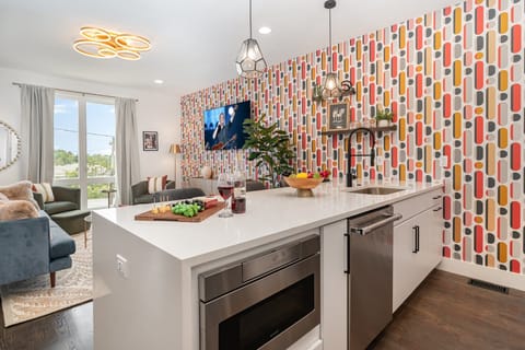 2nd Floor: Fully equipped kitchen with stainless steel appliances and a kitchen island with seating for 4 guests.