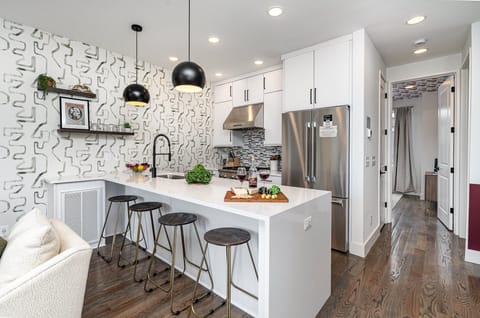 Fully equipped kitchen with stainless steel appliances and a kitchen island with seating for 4 guests. (2nd Floor)