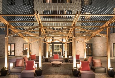 Gather outdoors under warm lighting for laid-back conversation