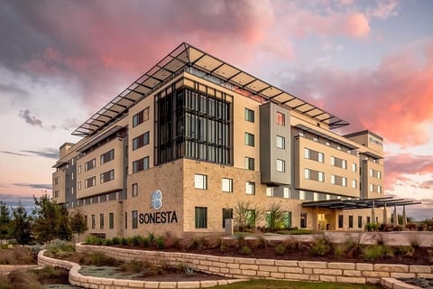 Discover a modern hotel glowing beautifully at sunset