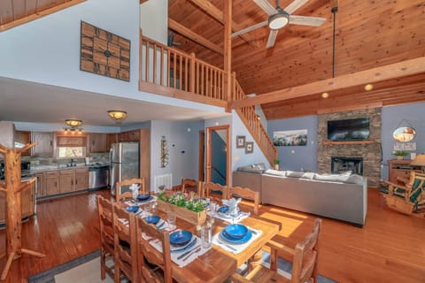 The beautiful open concept living space includes a seasonal fireplace, fully equipped kitchen and dining area for 8