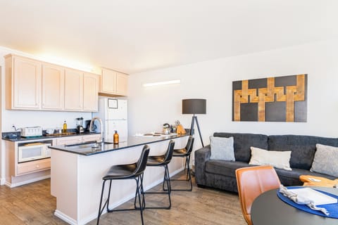 Fully equipped kitchen with barstool seating.