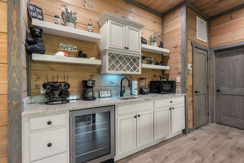 Lounge in style with a fireplace, wet bar, and cozy seating!