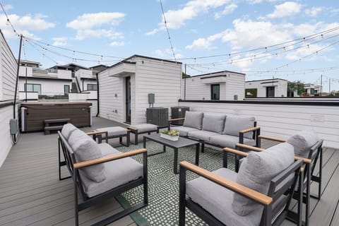 Unit 2 (4th Floor): Private Rooftop Patio featuring a hot tub and an outdoor lounge area.