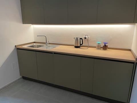 kitchen with sink, bin unit, 45cm dishwasher, washing machine and fridge