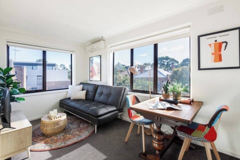 This sunlit living area is perfect for a relaxed evening after exploring nearby neighbourhood gems.
