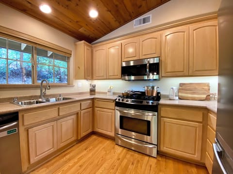 Fully stocked kitchen with cookware, rice cooker, blender and toaster oven.