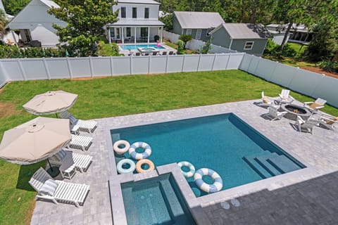 Backyard oasis with pool, hot tub, fire pit, loungers & putting green